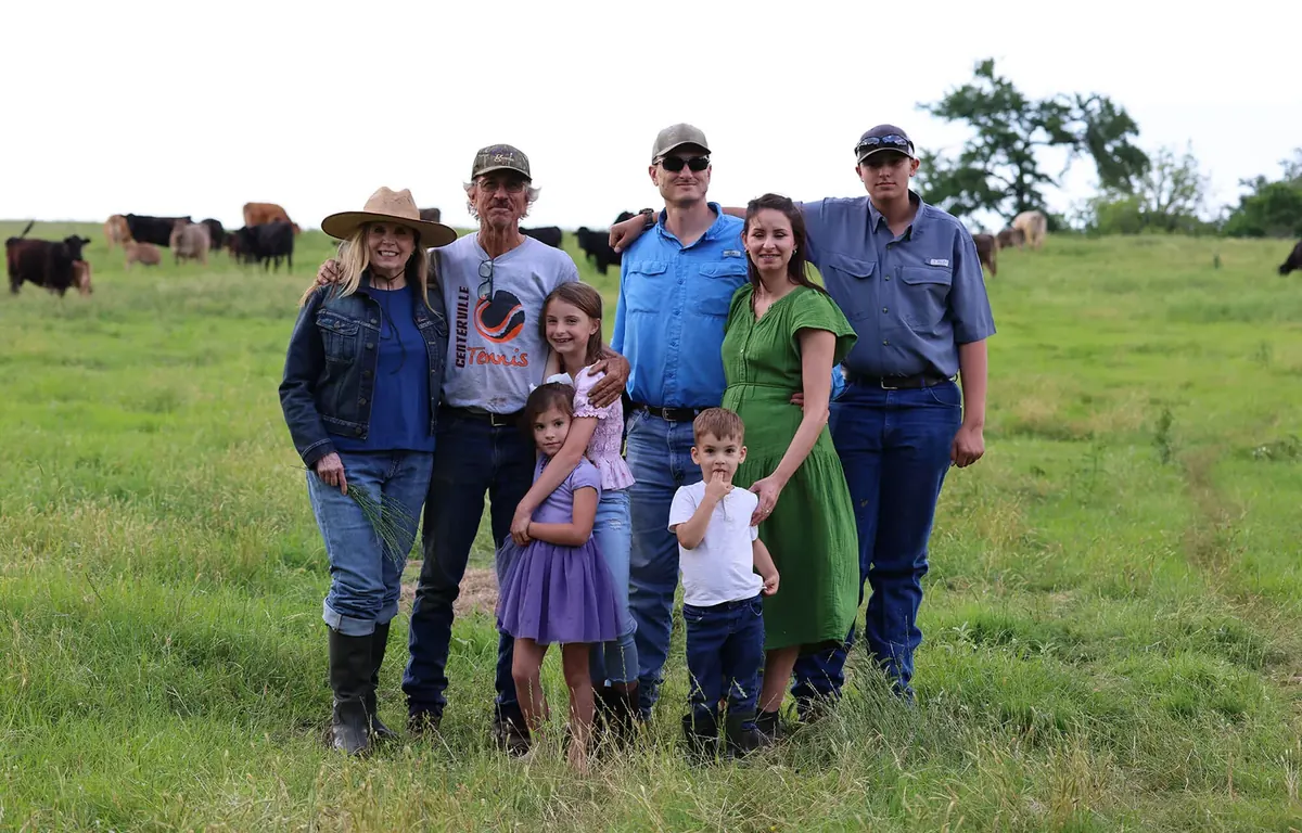 A ranching family standing in their pasture