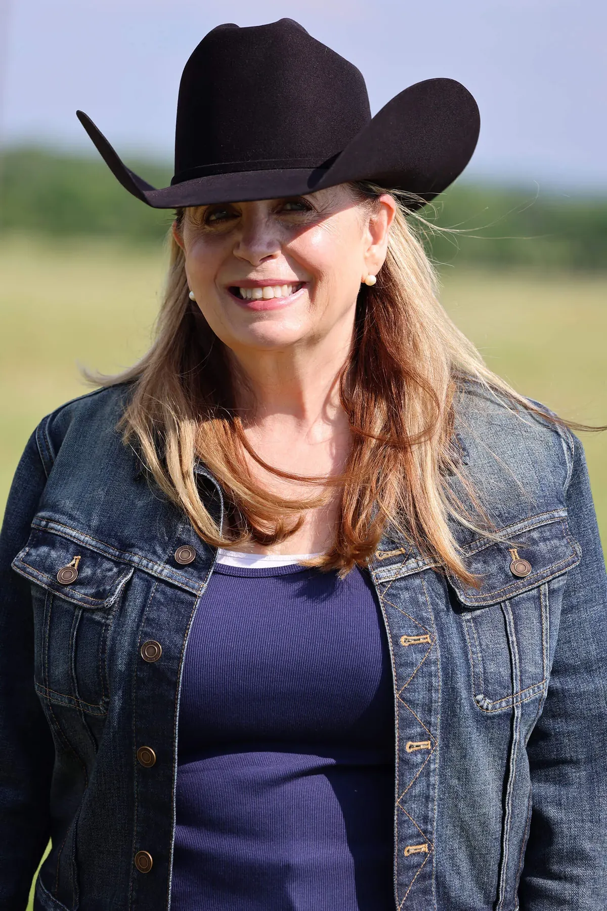Kat Wall in a denim jacket and hat